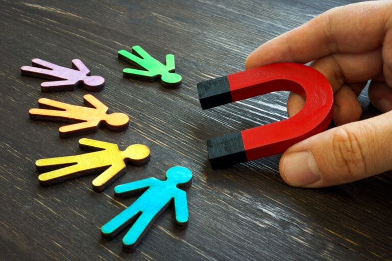 Retention marketing concept. The manager holds a magnet for customers